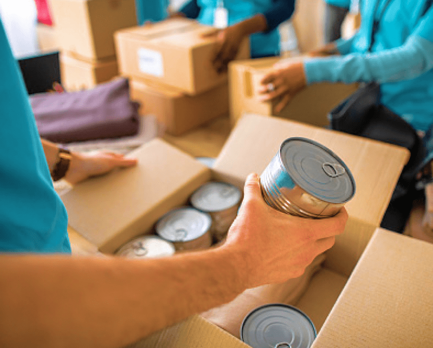 Image of a person putting a tin can into a box